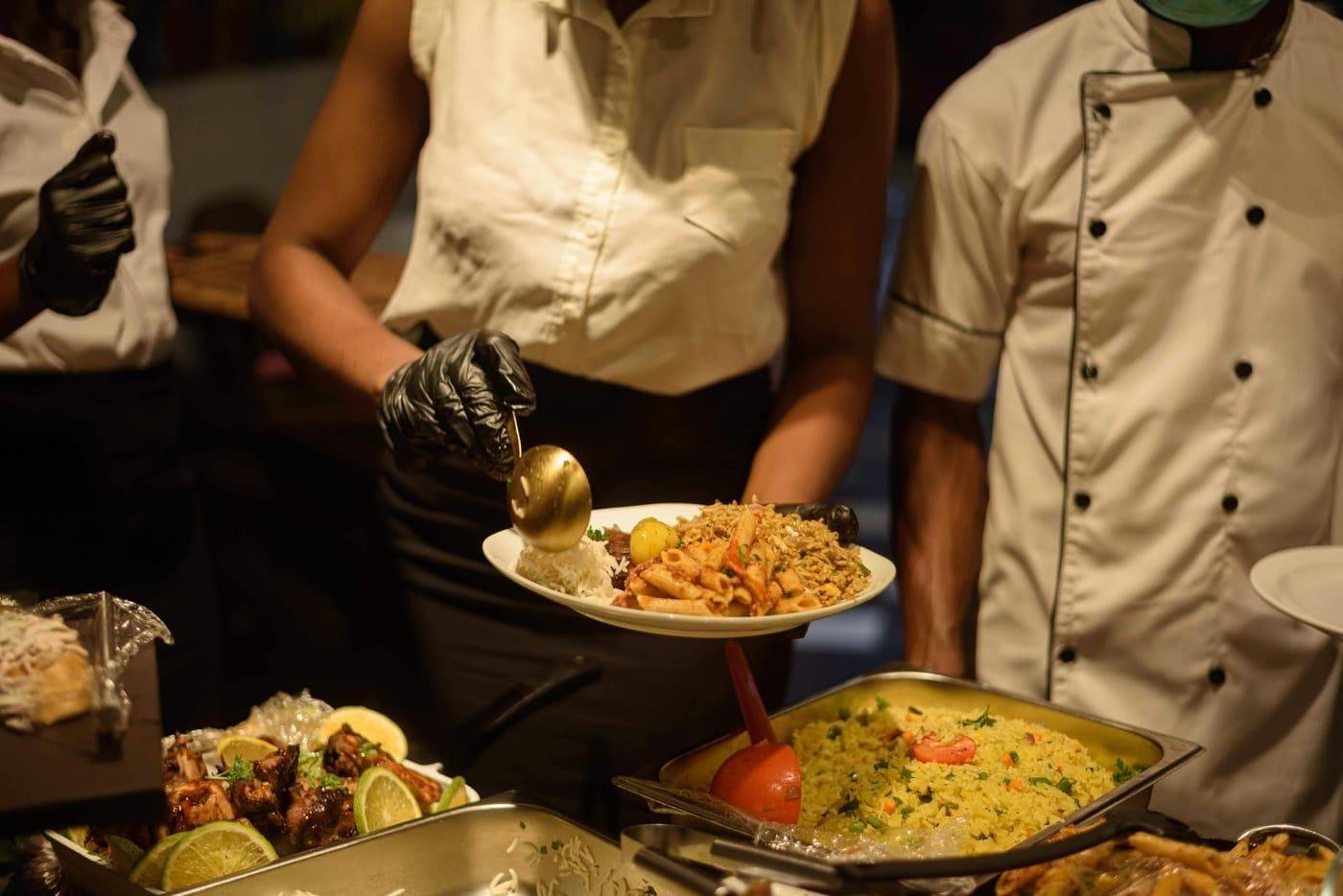 Professional catering service plating food for a private event