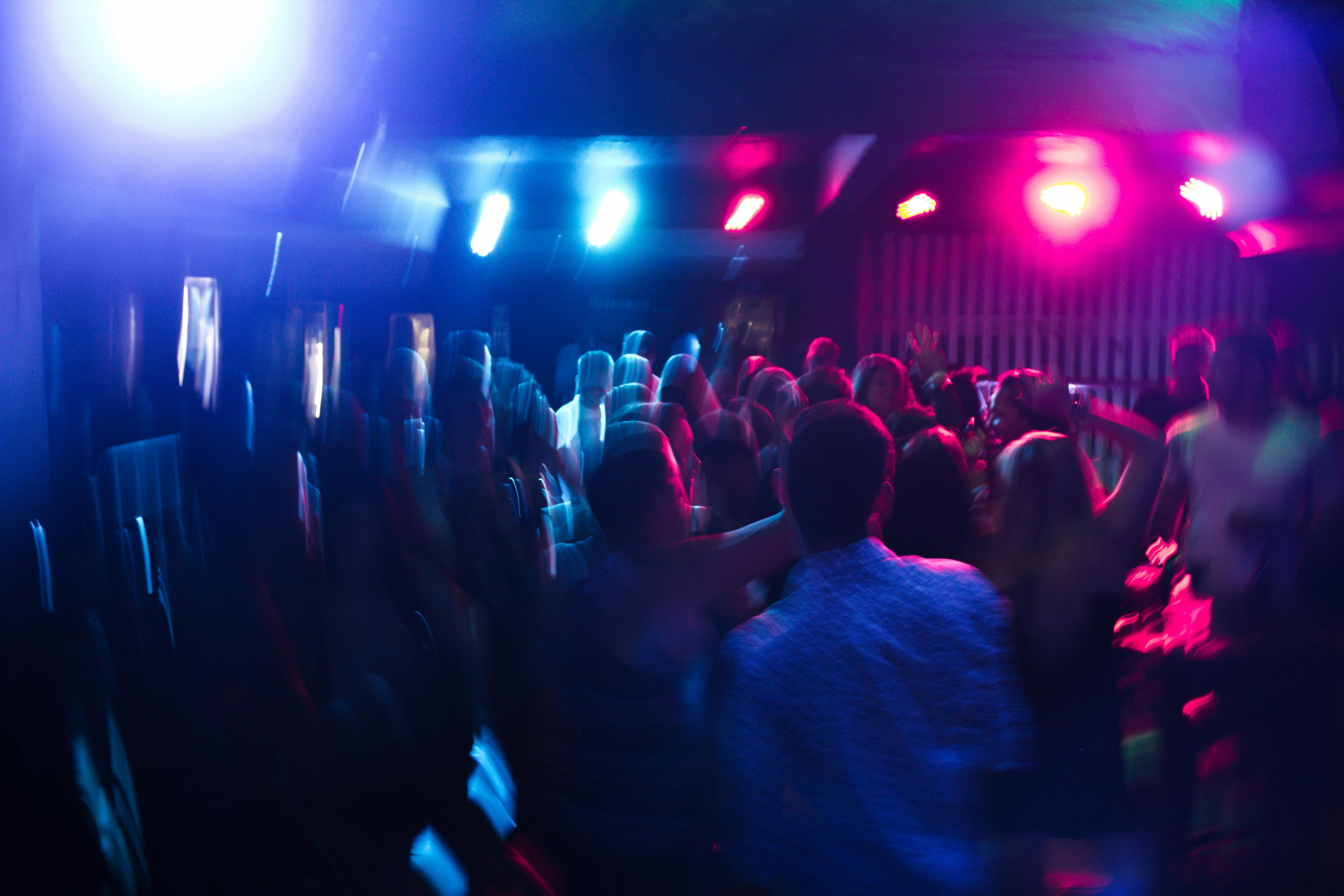 Crowded Punta Cana nightclub with colorful lighting